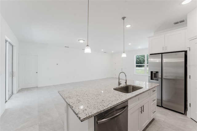 kitchen with decorative light fixtures, white cabinetry, appliances with stainless steel finishes, and sink