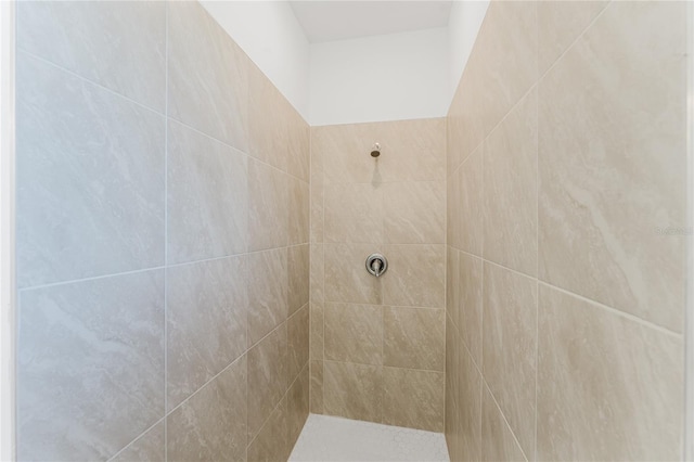 bathroom with a tile shower