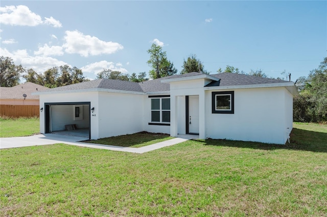 view of front of house featuring a front yard and a garage