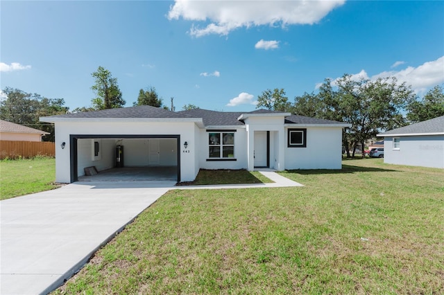 view of front of property featuring a front lawn and a garage