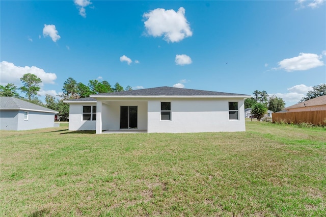 rear view of house with a patio area and a yard