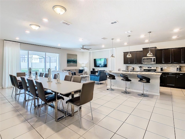 tiled dining room featuring ceiling fan