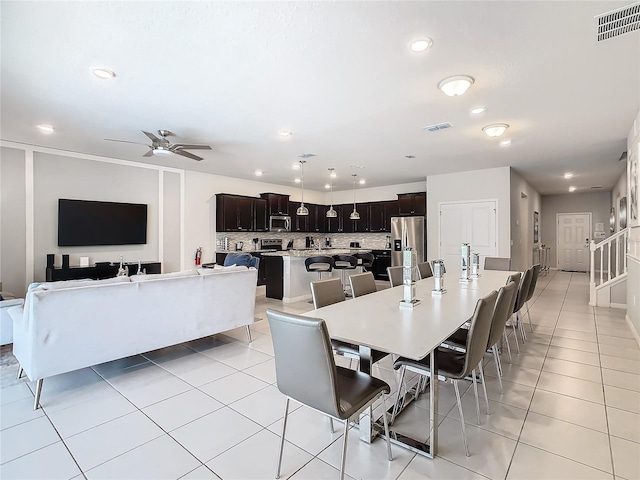 tiled dining room with ceiling fan