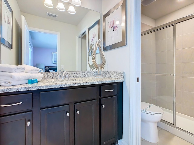 bathroom with vanity, toilet, and an enclosed shower