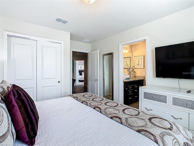 bedroom with ensuite bath and a closet