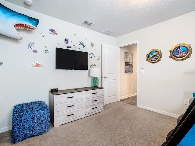 carpeted bedroom featuring a textured ceiling