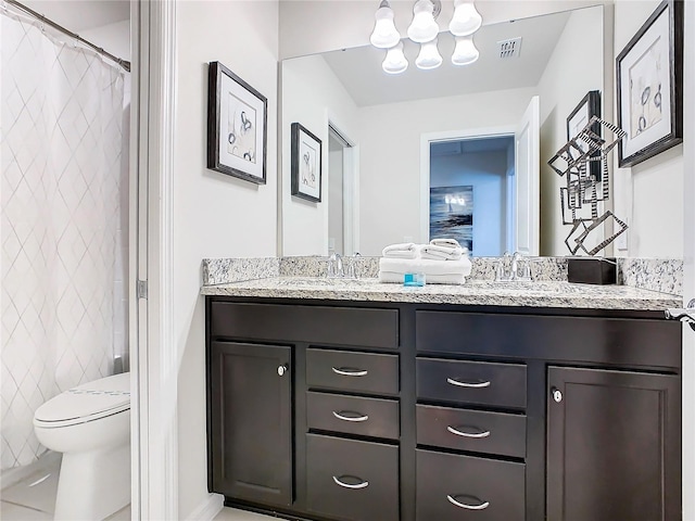 bathroom featuring tile walls, vanity, and toilet