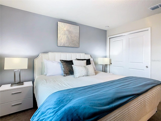 bedroom featuring dark carpet and a closet