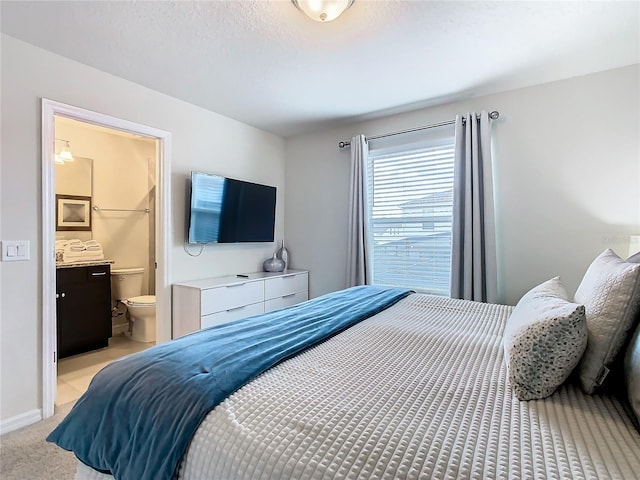 carpeted bedroom featuring connected bathroom