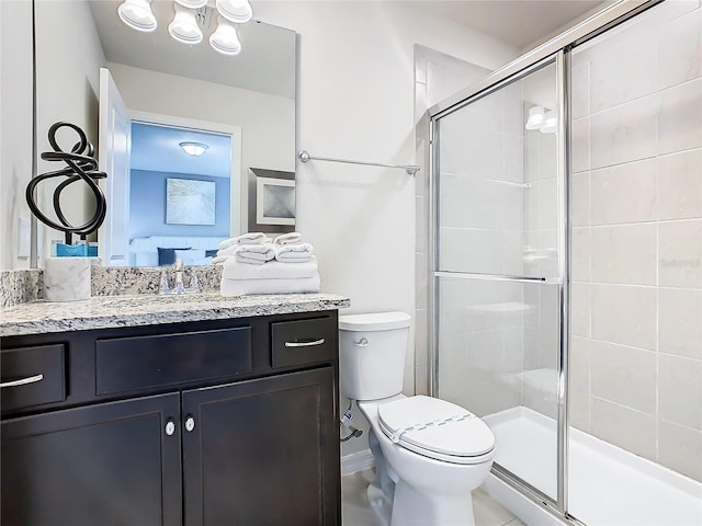 bathroom featuring vanity, toilet, and an enclosed shower