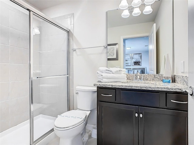 bathroom featuring walk in shower, vanity, and toilet