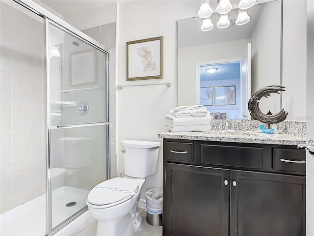 bathroom with walk in shower, vanity, and toilet