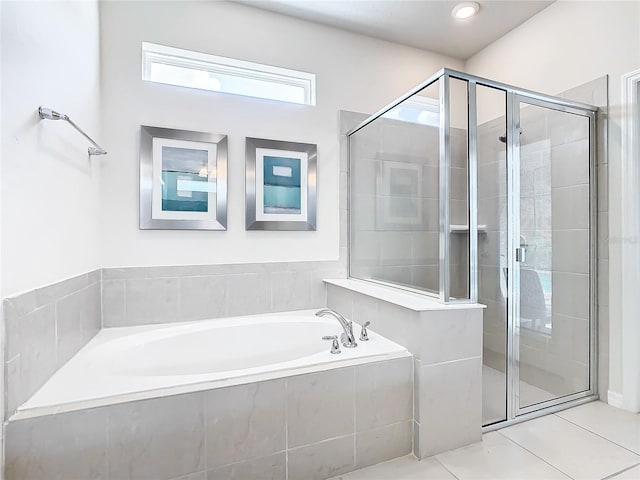 bathroom featuring plus walk in shower and tile patterned flooring