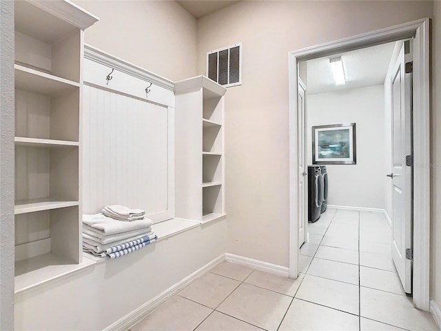 interior space featuring light tile patterned floors and washing machine and clothes dryer