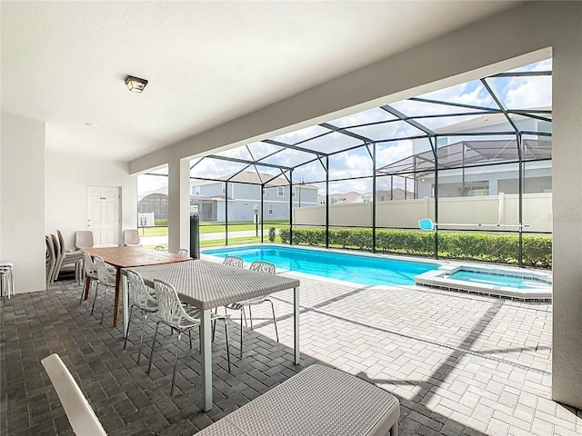 view of pool featuring a lanai, a patio, and an in ground hot tub