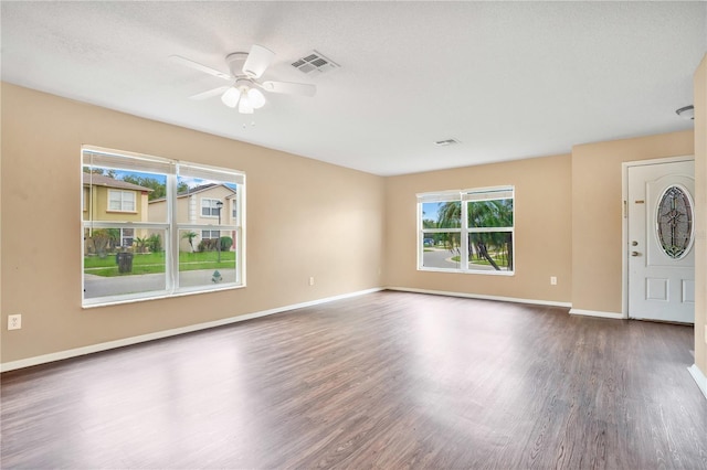 interior space featuring ceiling fan, dark hardwood / wood-style floors, and a textured ceiling