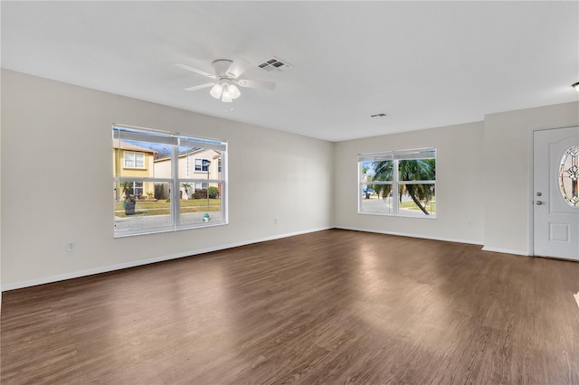 unfurnished living room featuring dark hardwood / wood-style floors and ceiling fan