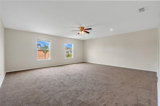 unfurnished room featuring ceiling fan, carpet floors, and a textured ceiling