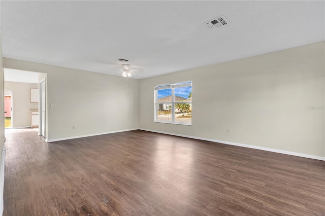 unfurnished room with dark hardwood / wood-style floors and ceiling fan