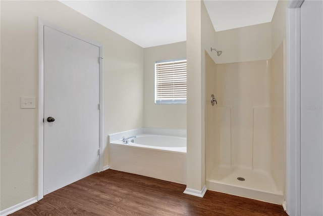 bathroom featuring hardwood / wood-style flooring and independent shower and bath