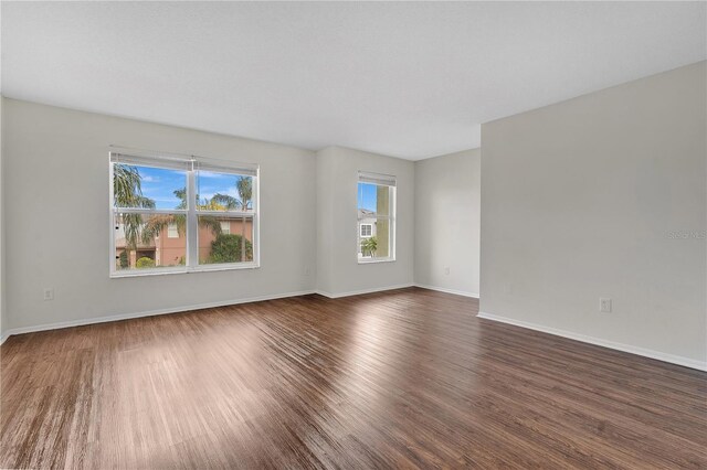 empty room featuring dark hardwood / wood-style flooring