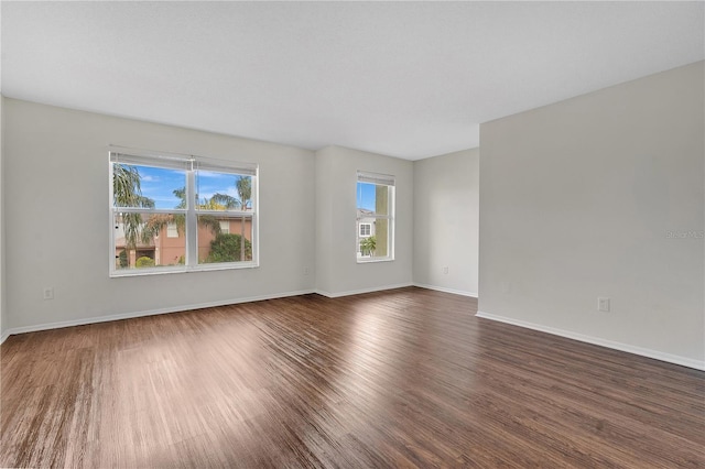 spare room with dark wood-type flooring