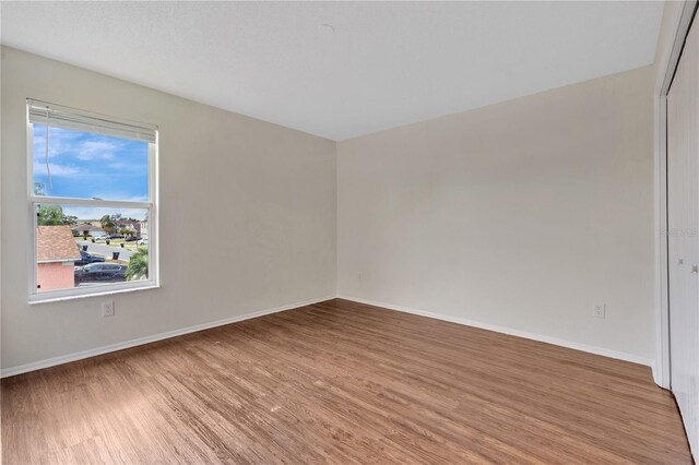 spare room with wood-type flooring
