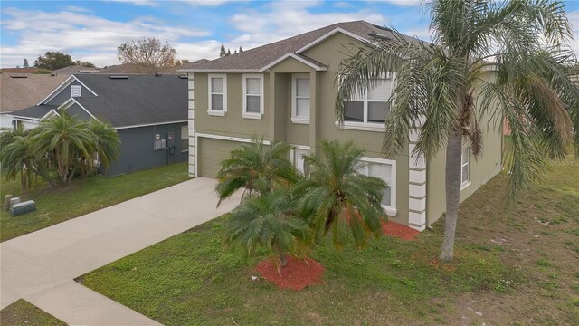 view of front of property with a garage and a front lawn