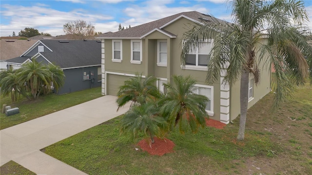 view of front of property featuring a garage and a front lawn