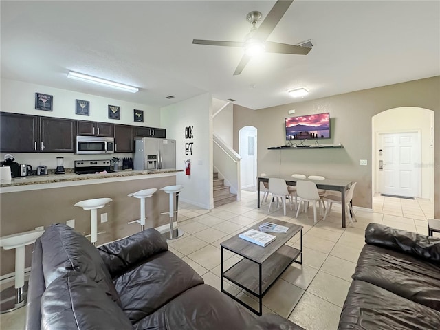 tiled living room with ceiling fan