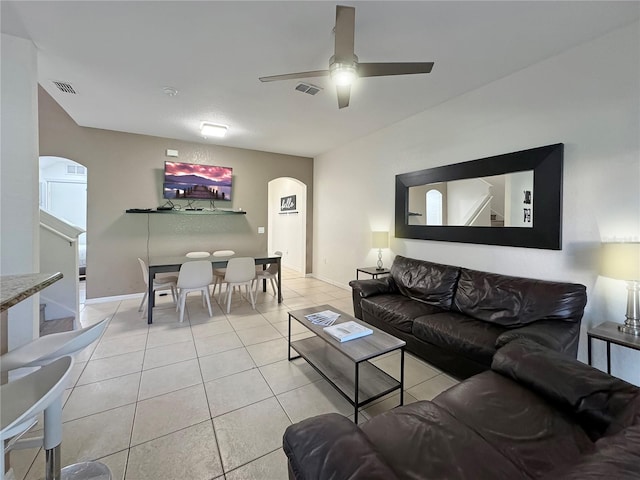 living room with ceiling fan and light tile patterned flooring