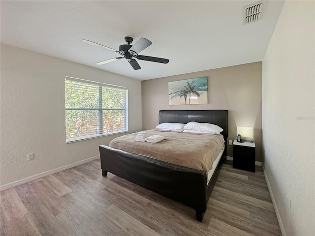 bedroom with wood-type flooring and ceiling fan