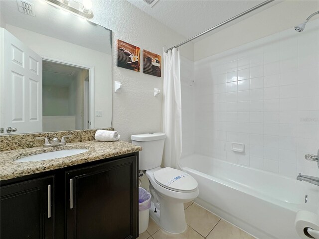 full bathroom with vanity, shower / bath combo, a textured ceiling, tile patterned floors, and toilet