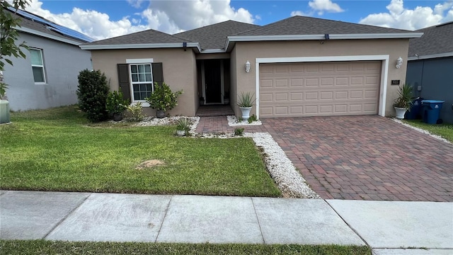 view of front of house featuring a garage and a front lawn