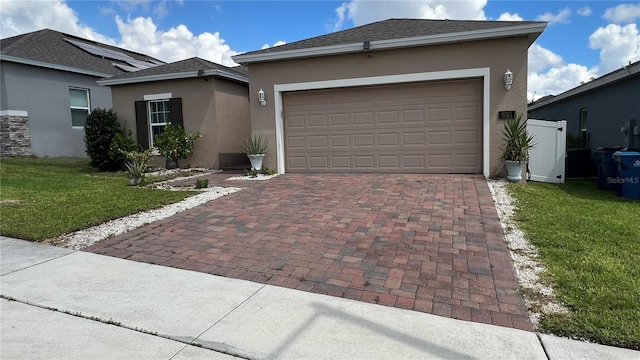 view of front facade featuring a front yard and a garage