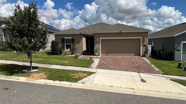 view of front of house featuring a garage and a front lawn