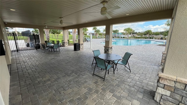 view of patio / terrace with ceiling fan and a community pool