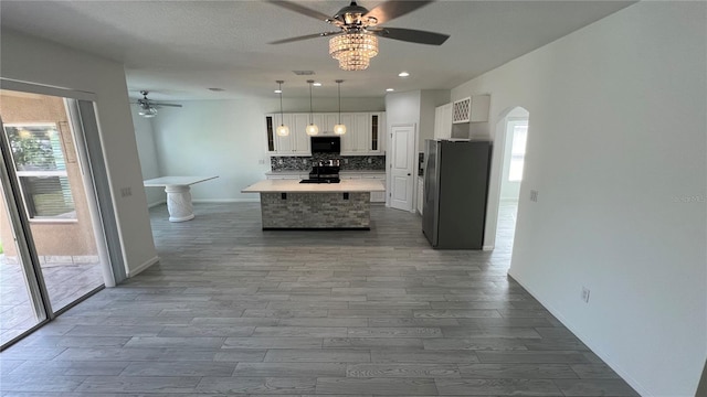 kitchen with white cabinets, a healthy amount of sunlight, and black appliances