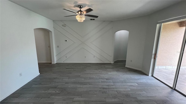 unfurnished room with a textured ceiling, ceiling fan, and dark hardwood / wood-style floors