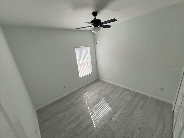 spare room with light wood-type flooring and ceiling fan