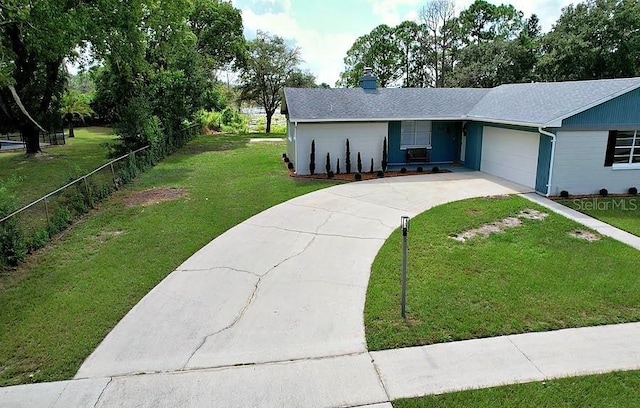 single story home featuring a chimney, concrete driveway, an attached garage, a front yard, and fence