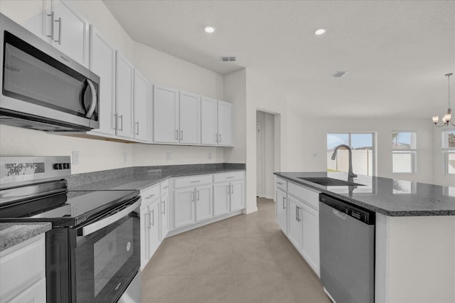 kitchen with white cabinetry, a notable chandelier, stainless steel appliances, and sink