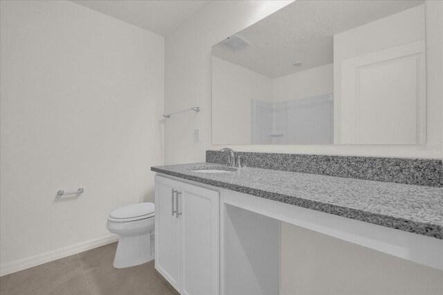 bathroom featuring vanity, toilet, and tile patterned floors