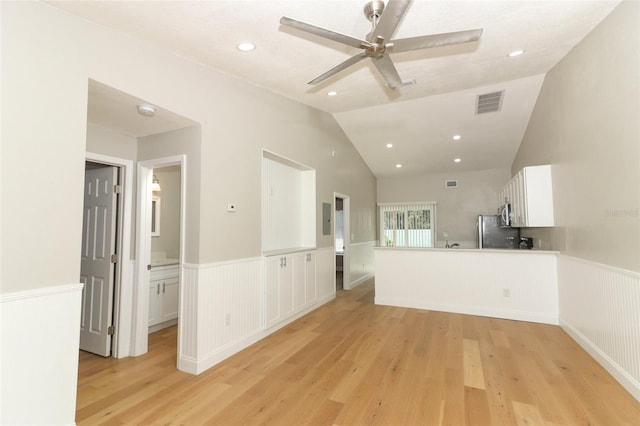 unfurnished room featuring ceiling fan, light wood-type flooring, and vaulted ceiling