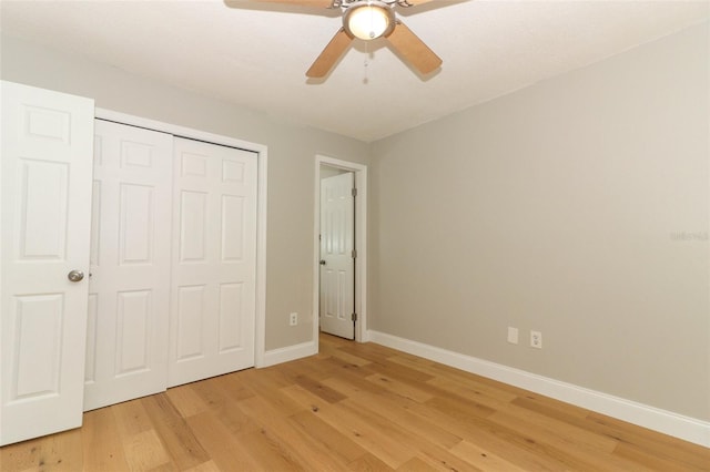 unfurnished bedroom featuring ceiling fan, light wood-type flooring, and a closet