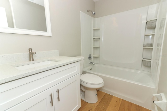 full bathroom with vanity, shower / bathing tub combination, hardwood / wood-style flooring, and toilet