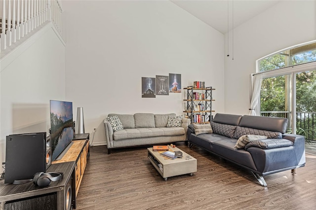 living room featuring dark hardwood / wood-style flooring and high vaulted ceiling