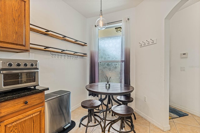 kitchen with pendant lighting and light tile patterned flooring