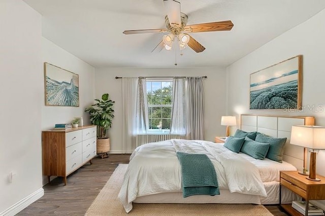 bedroom with ceiling fan and dark hardwood / wood-style floors