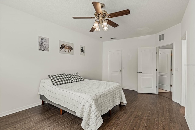 bedroom featuring a textured ceiling, dark hardwood / wood-style flooring, and ceiling fan